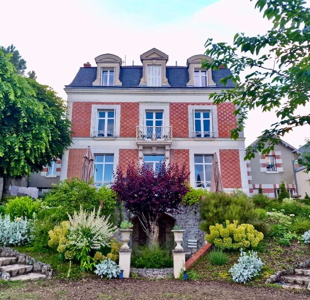 Garden and facade of the Nineteeth Century Manor House at Maison Loire, a luxury chambre d'hôtes or bed and breakfast overlooking the Loire river.