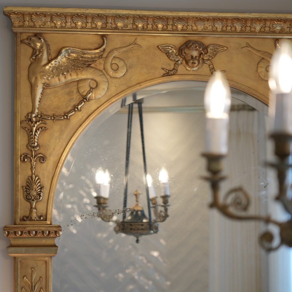 An Empire period chandelier and elegant mirror in the Curiosités en suite bathroom at Maison Loire Bed and Breakfast.