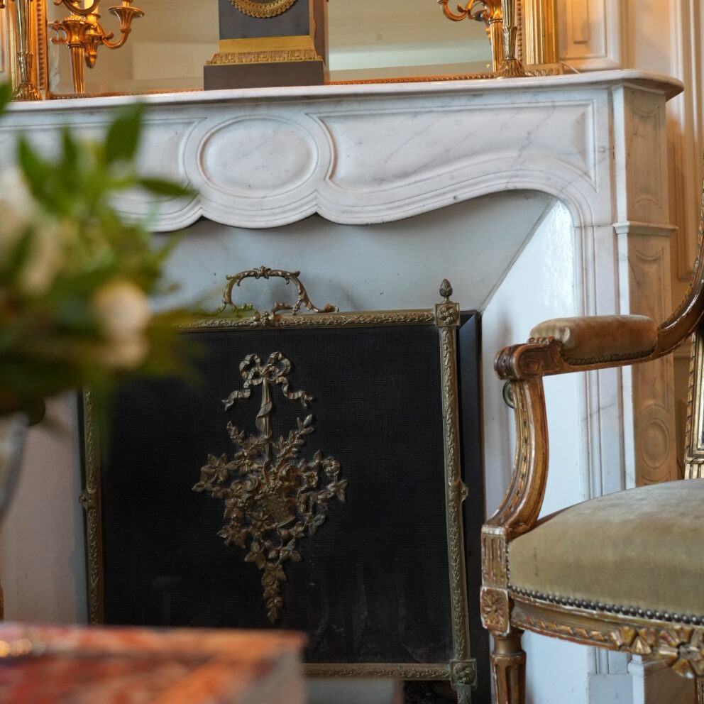 An authentic period marble fireplace and mantlepiece inside our 19th century manor house, reflecting French heritage design.
