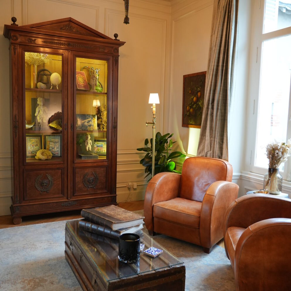 A sophisticated bibliotheque, or library, with Art Deco period leather club chairs and antique decor at our Blois chambre d'hôtes bed and breakfast.