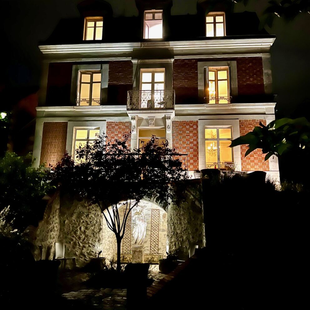 The illuminated exterior of Maison Loire in Blois, showcasing the magic of this historic French manor house at night.